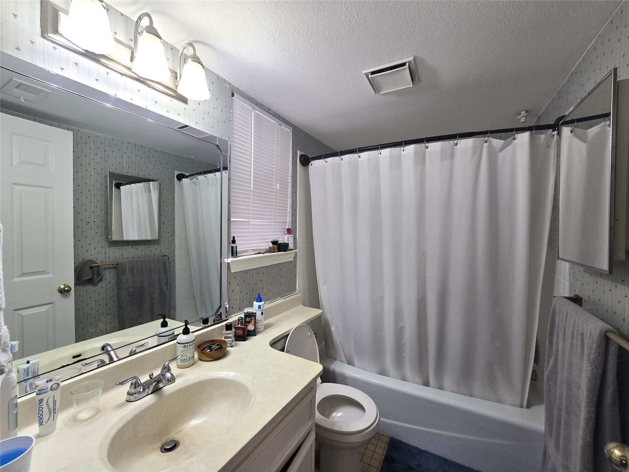 706 West 22nd Street, Unit 307 Austin, TX 78705 - Photo 9 of 20 a bathroom with a sink toilet and shower