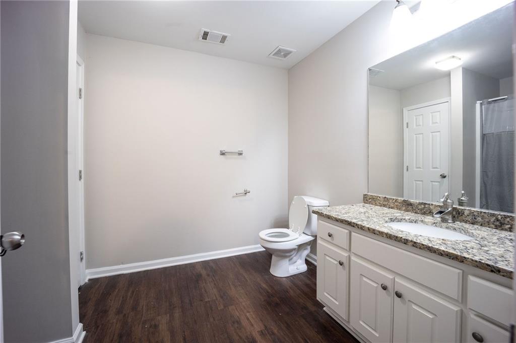 1468 Box Circle Winder, GA 30680 - Photo 16 of 33 a bathroom with a granite countertop sink toilet and a mirror