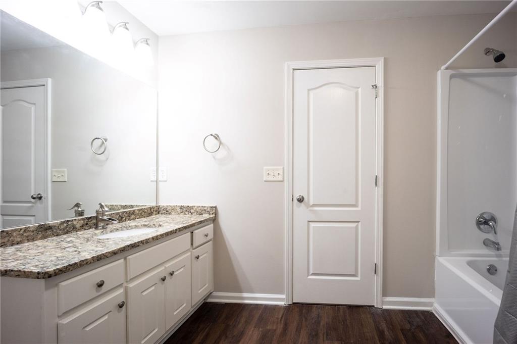 1468 Box Circle Winder, GA 30680 - Photo 17 of 33 a bathroom with a granite countertop sink and a mirror