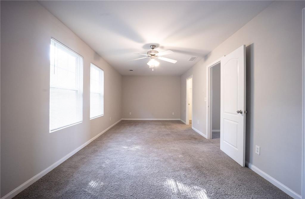 1468 Box Circle Winder, GA 30680 - Photo 24 of 33 an empty room with windows and a ceiling fan