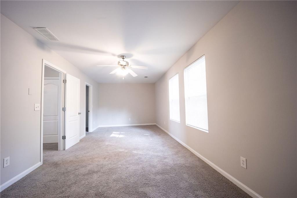 1468 Box Circle Winder, GA 30680 - Photo 25 of 33 an empty room with windows and chandelier fan