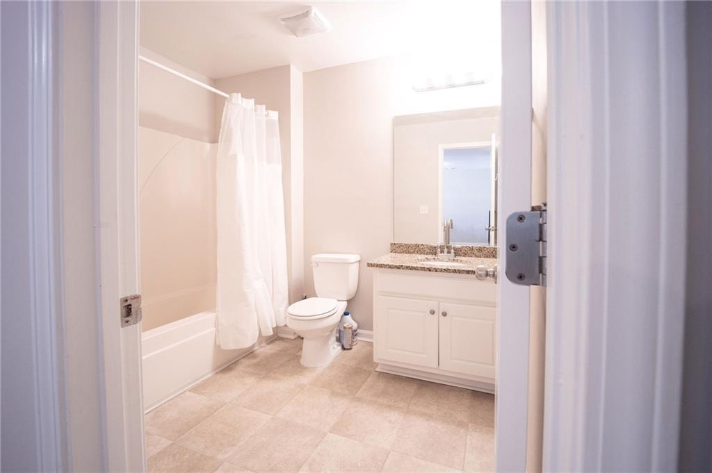 1468 Box Circle Winder, GA 30680 - Photo 27 of 33 a bathroom with a granite countertop sink toilet and shower