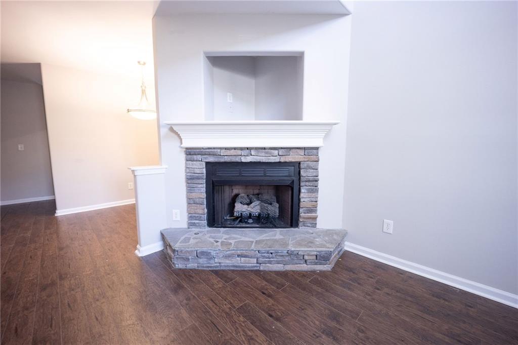 1468 Box Circle Winder, GA 30680 - Photo 6 of 33 a living room with wooden floor and a fireplace