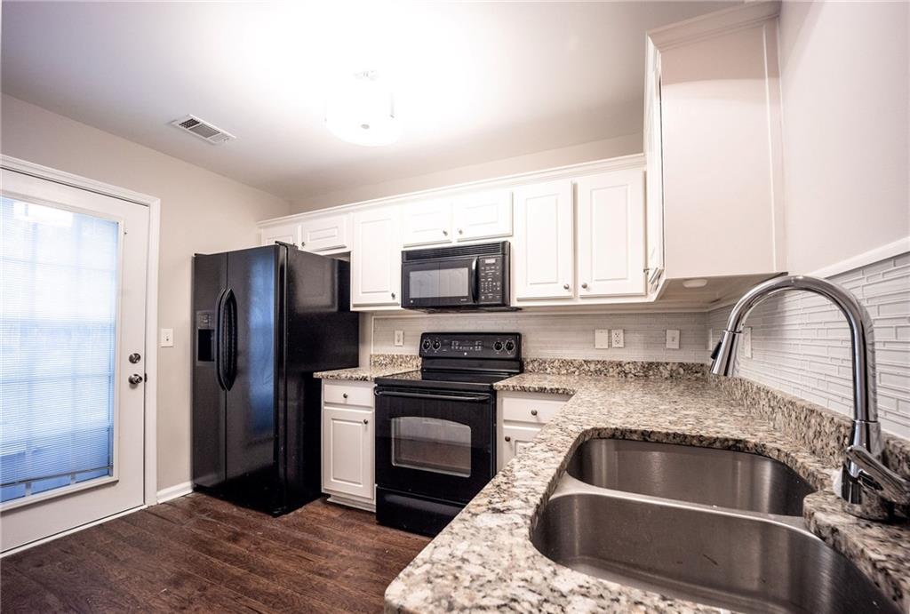 1468 Box Circle Winder, GA 30680 - Photo 8 of 33 a kitchen with a refrigerator sink and cabinets