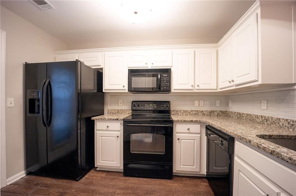 1468 Box Circle Winder, GA 30680 - Photo 9 of 33 a kitchen with stainless steel appliances granite countertop a stove microwave and refrigerator