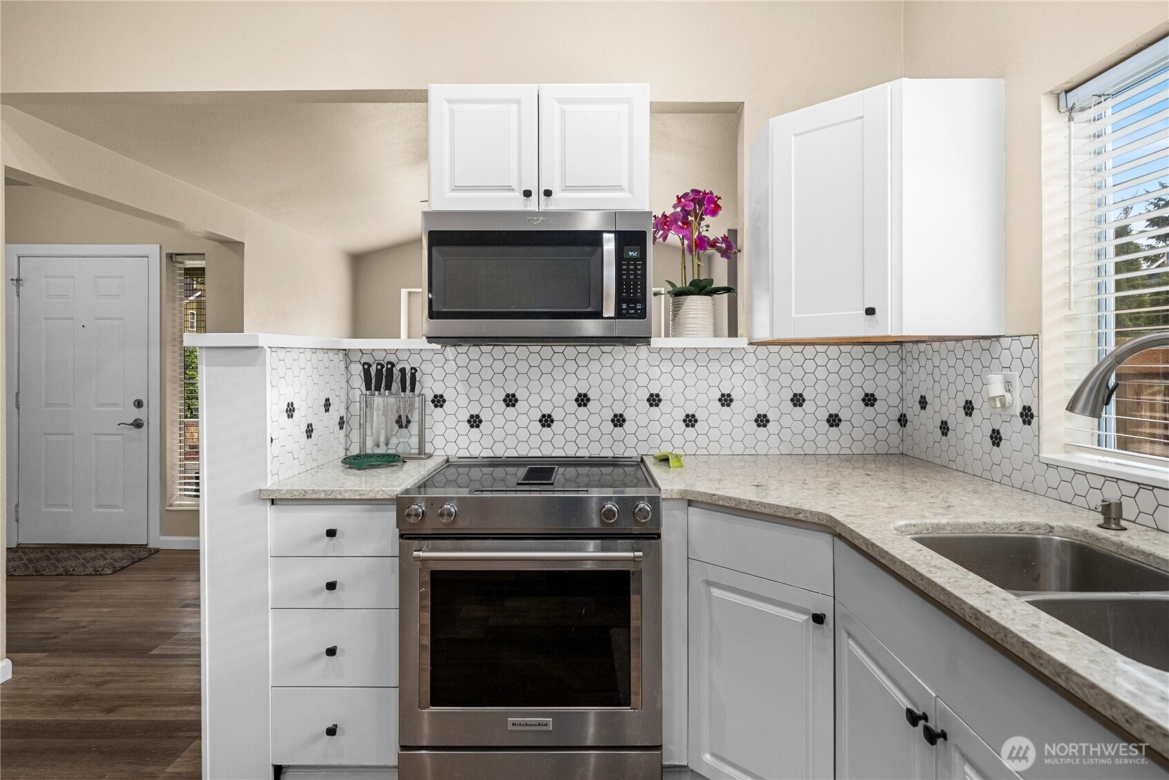 24501 234th Way Southeast Maple Valley, WA 98038 - Photo 21 of 34 a kitchen with granite countertop a sink stove and white cabinets
