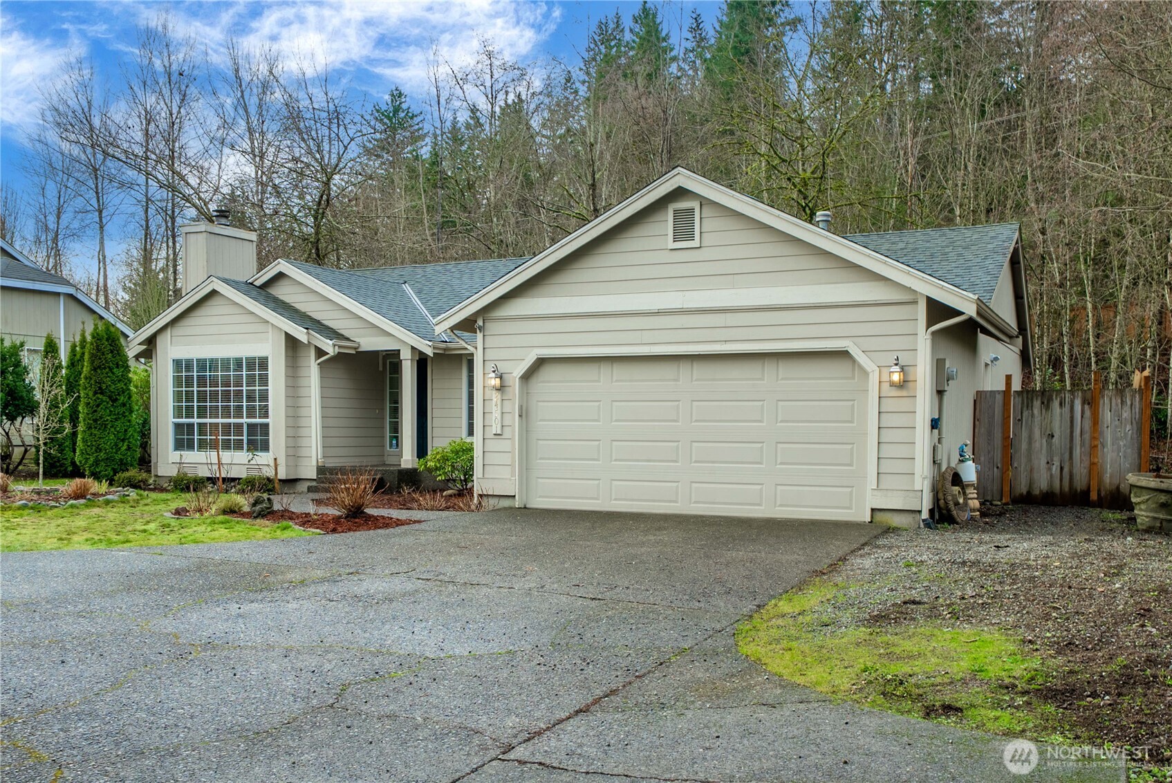 24501 234th Way Southeast Maple Valley, WA 98038 - Photo 3 of 34 a front view of a house with a yard and garage