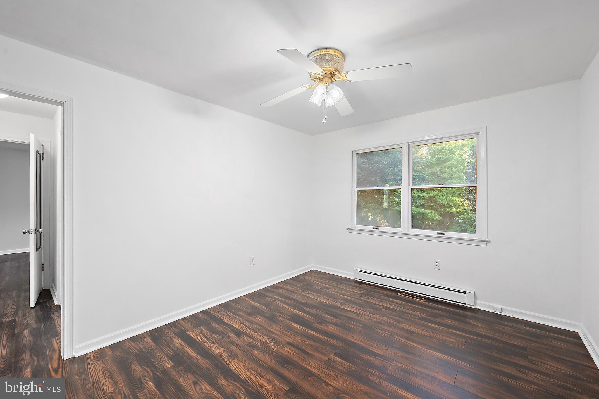 6181 Rockawalkin Road Salisbury, MD 21801 - Photo 21 of 65 a view of an empty room with wooden floor and a window