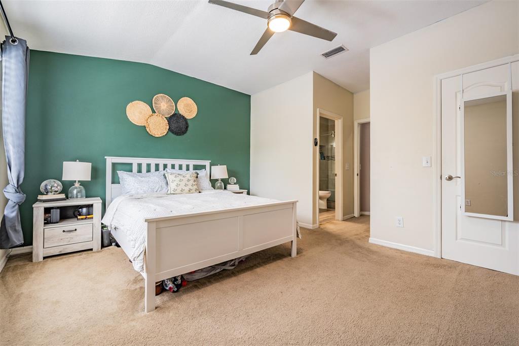 5886 Fishhawk Ridge Drive Lithia, FL 33547 - Photo 14 of 37 a bed room with a bed and a painting on the wall