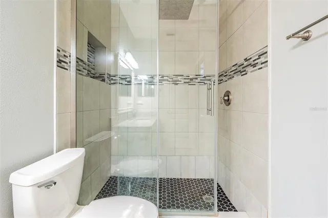 a bathroom with a shower toilet and sink