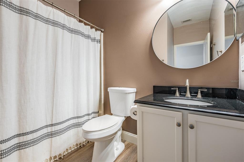 5886 Fishhawk Ridge Drive Lithia, FL 33547 - Photo 18 of 37 a bathroom with a toilet a sink and a mirror