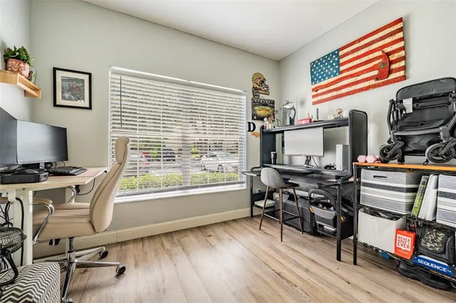 a view of a workspace with furniture and a window