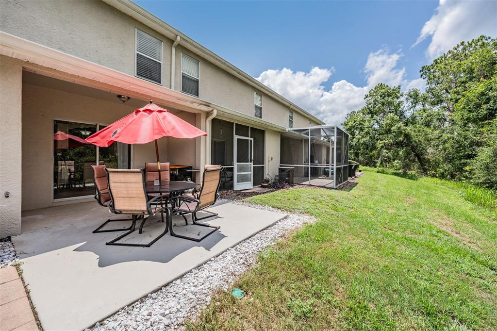 5886 Fishhawk Ridge Drive Lithia, FL 33547 - Photo 24 of 37 a view of a patio with a table and chairs under an umbrella
