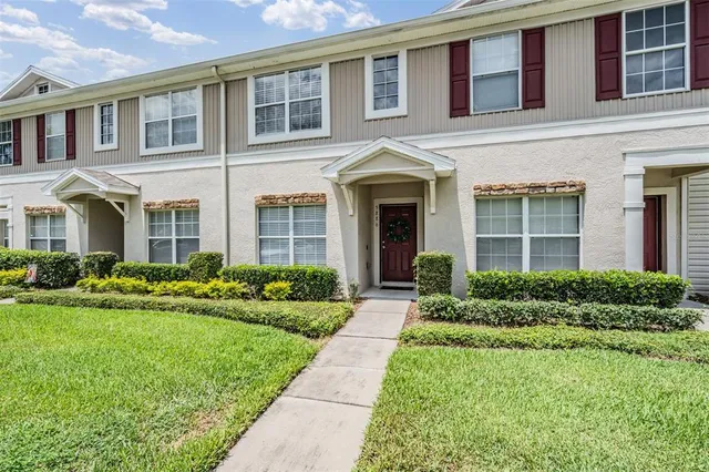 a front view of a house with garden and porch