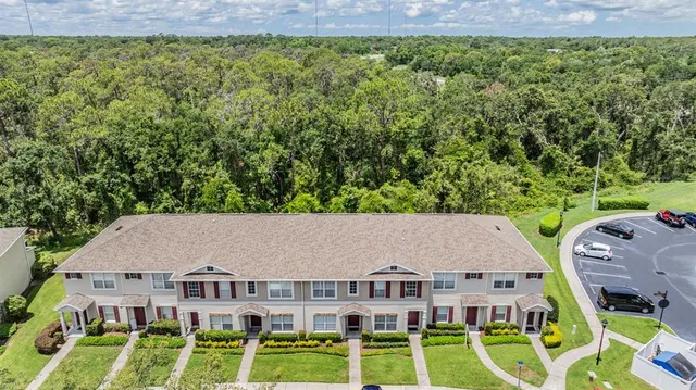 a aerial view of residential houses with yard and green space
