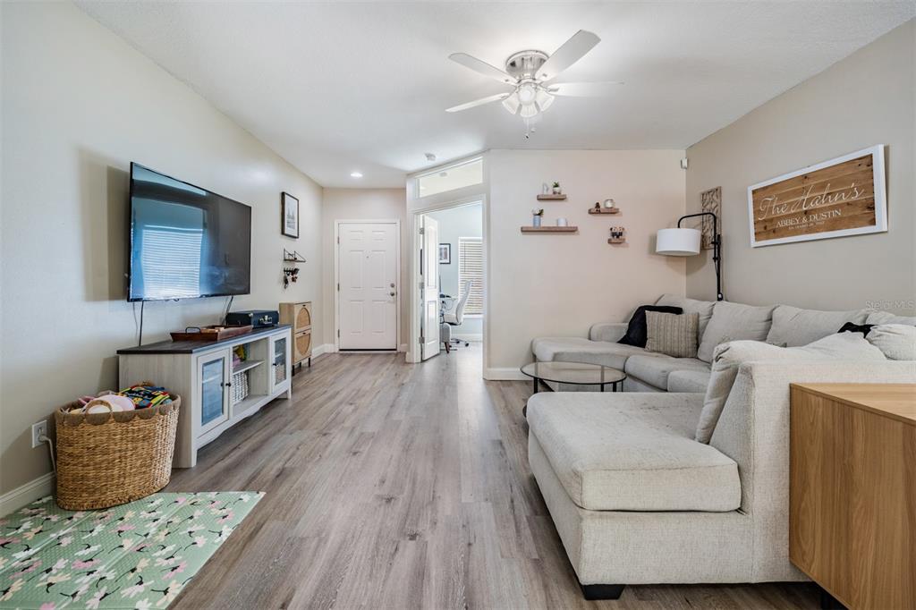 5886 Fishhawk Ridge Drive Lithia, FL 33547 - Photo 5 of 37 a living room with furniture and a flat screen tv