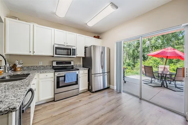 a kitchen with a stove a sink and a refrigerator