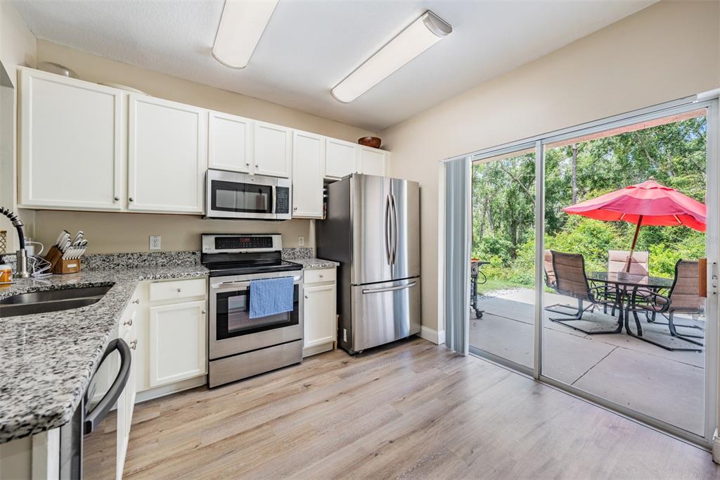 5886 Fishhawk Ridge Drive Lithia, FL 33547 - Photo 9 of 37 a kitchen with a stove a sink and a refrigerator