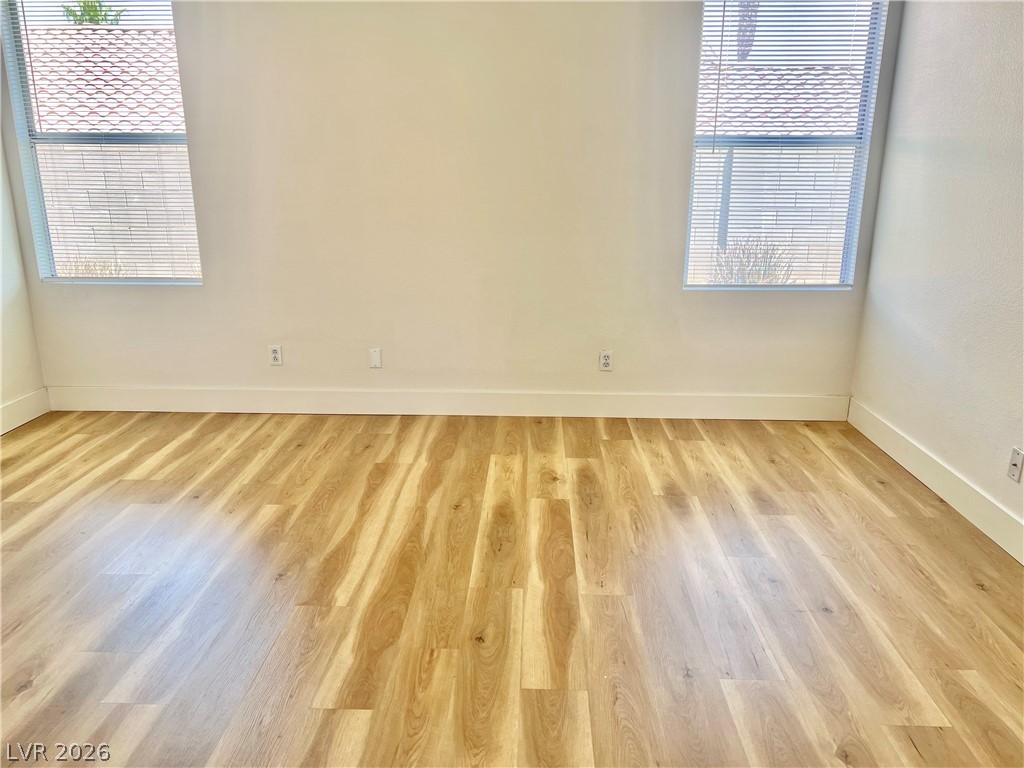 9708 Ridge Creek Place Las Vegas, NV 89134 - Photo 24 of 34 Primary bedroom. Luxury vinyl plank flooring and natural light create a welcoming and adaptable interior space.