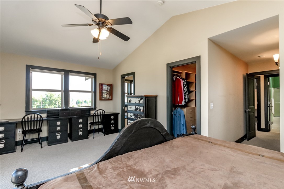 1203 South 3rd Street Renton, WA 98057 - Photo 17 of 40 a bed room with a bed and a chandelier