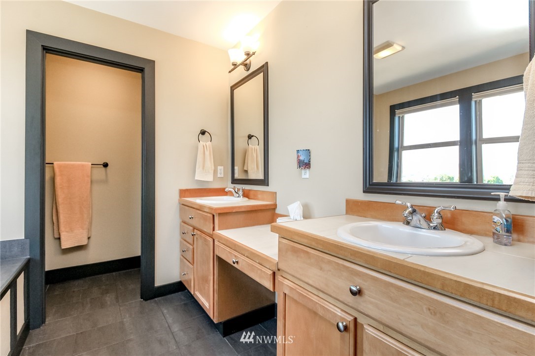 1203 South 3rd Street Renton, WA 98057 - Photo 19 of 40 a bathroom with a sink and a mirror