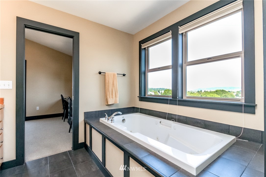 1203 South 3rd Street Renton, WA 98057 - Photo 20 of 40 a bath tub sitting next to a window