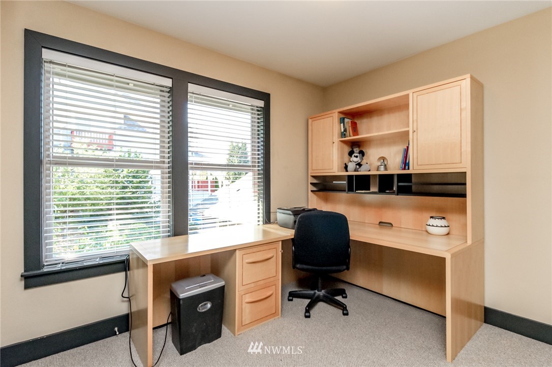 1203 South 3rd Street Renton, WA 98057 - Photo 22 of 40 a view of a workspace with furniture and a window
