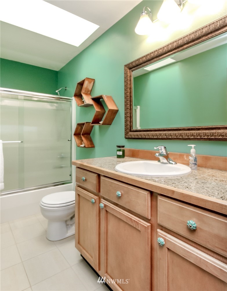 1203 South 3rd Street Renton, WA 98057 - Photo 24 of 40 a bathroom with a toilet sink and mirror
