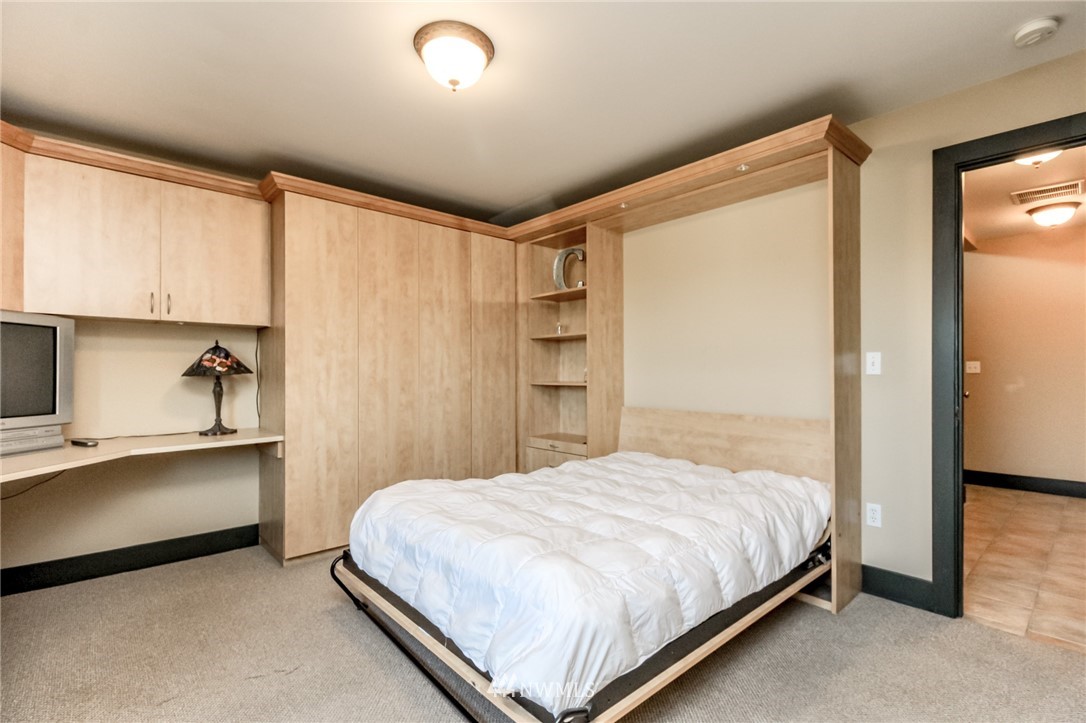 1203 South 3rd Street Renton, WA 98057 - Photo 27 of 40 a bedroom with a bed and a window