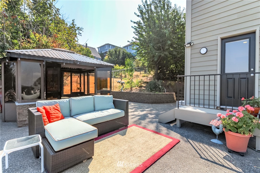 1203 South 3rd Street Renton, WA 98057 - Photo 33 of 40 a view of a patio with couches and a table and chairs with wooden floor
