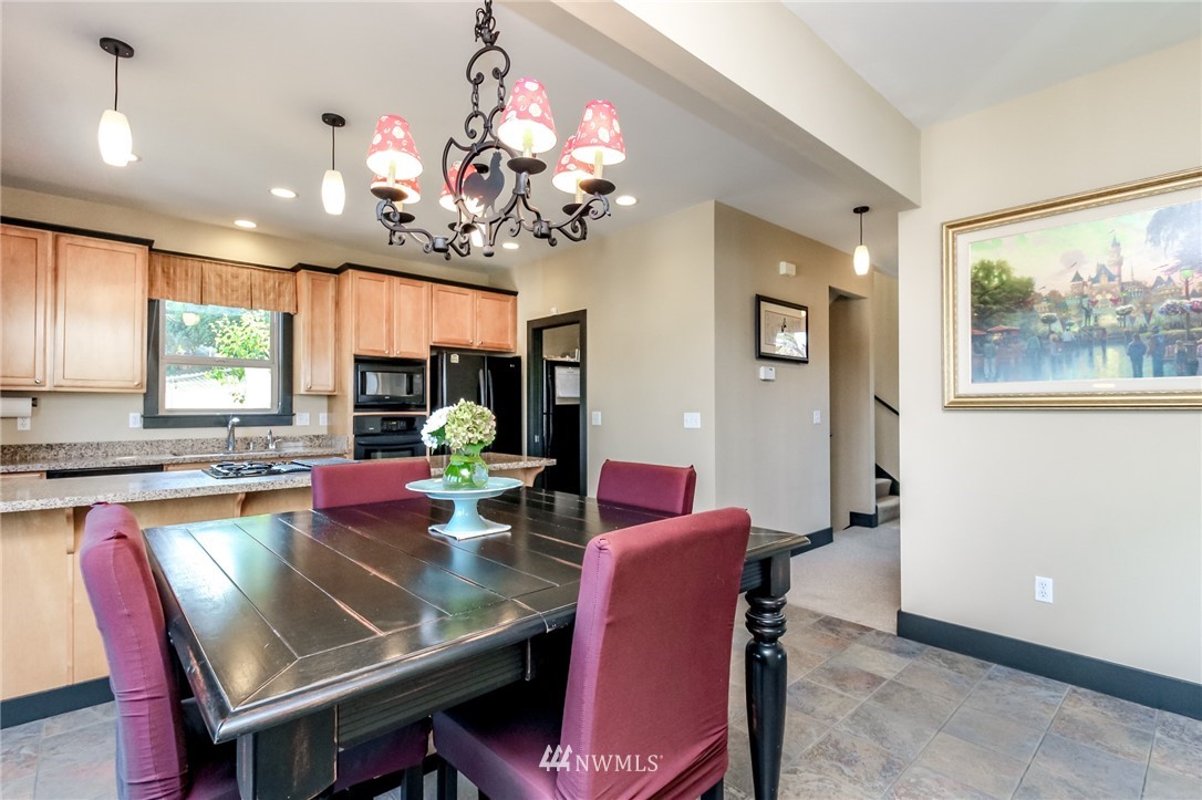 1203 South 3rd Street Renton, WA 98057 - Photo 9 of 40 a view of a dining room with furniture a chandelier and window