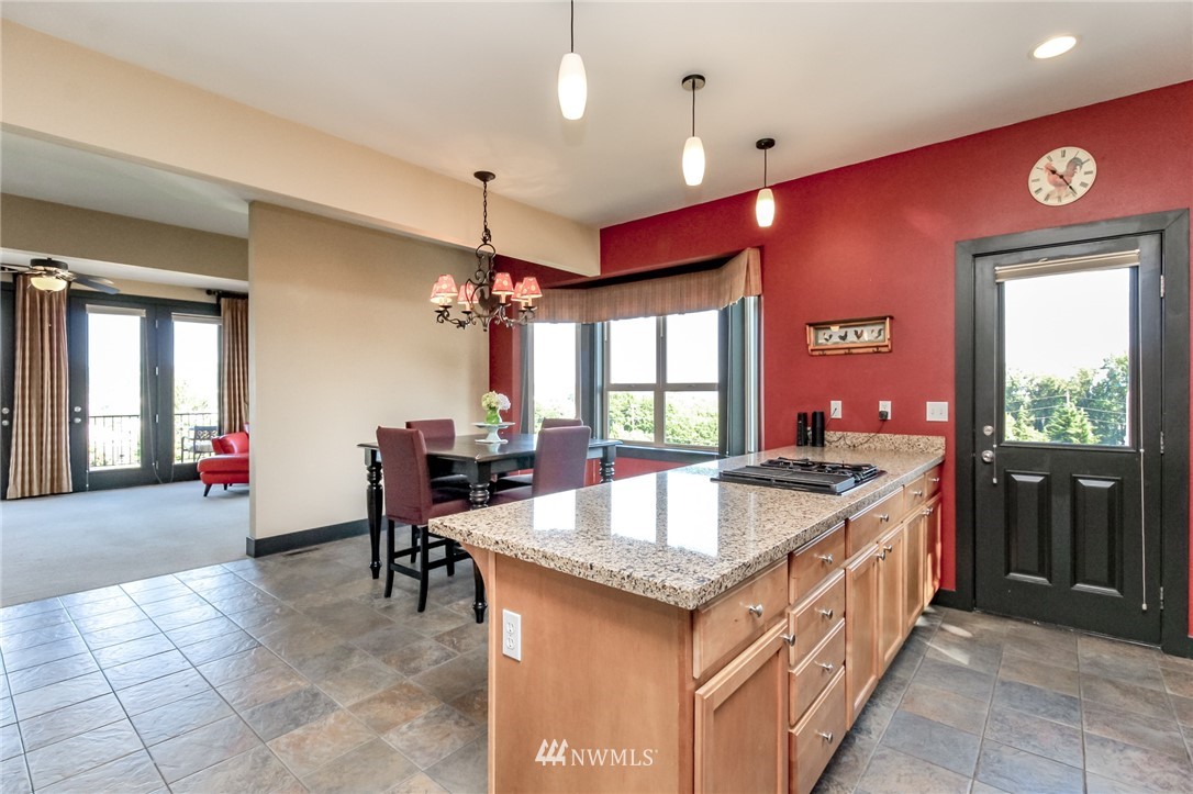 1203 South 3rd Street Renton, WA 98057 - Photo 10 of 40 a kitchen with granite countertop a sink and chairs