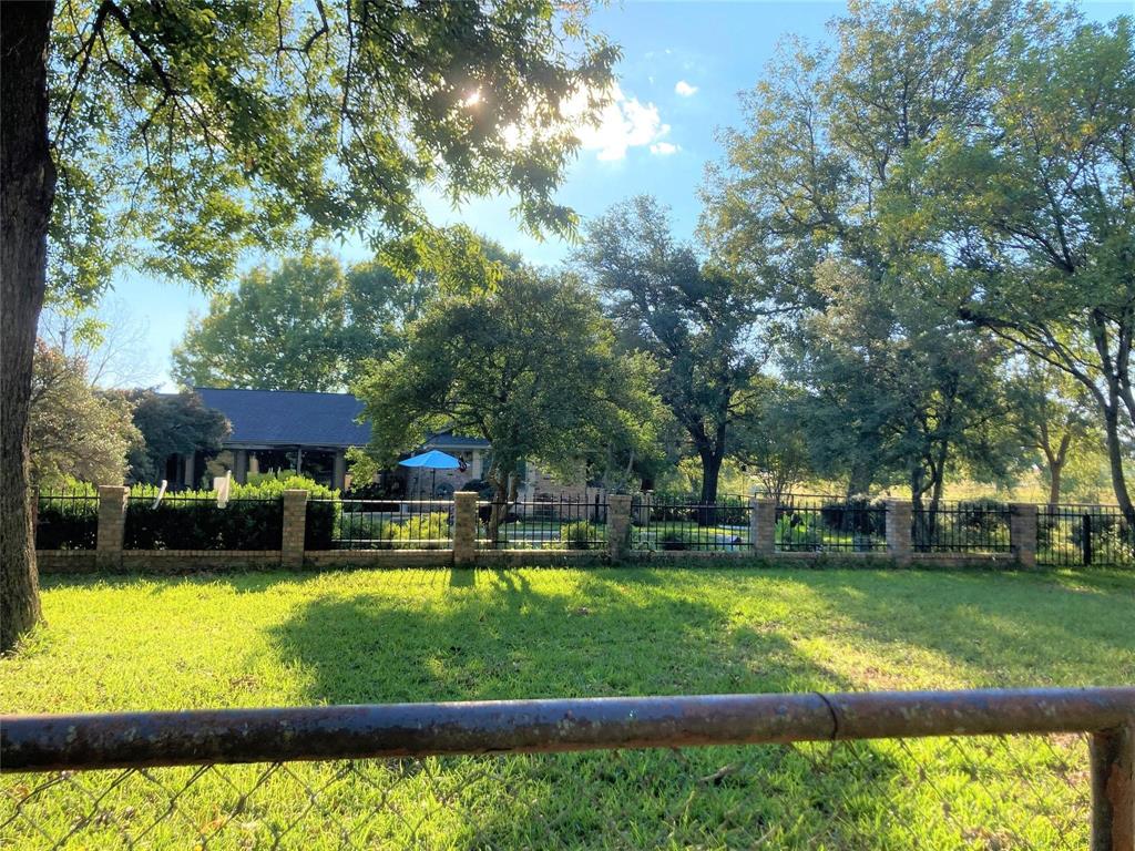 2815 Farm To Market Road 3092 Gainesville, TX 76240 - Photo 18 of 28 a view of a swimming pool with lawn chairs and a big yard
