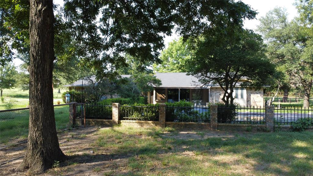 2815 Farm To Market Road 3092 Gainesville, TX 76240 - Photo 3 of 28 a view of a house with backyard and a tree