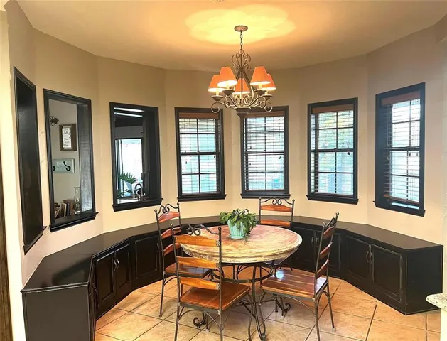 a view of a dining room with furniture and chandelier