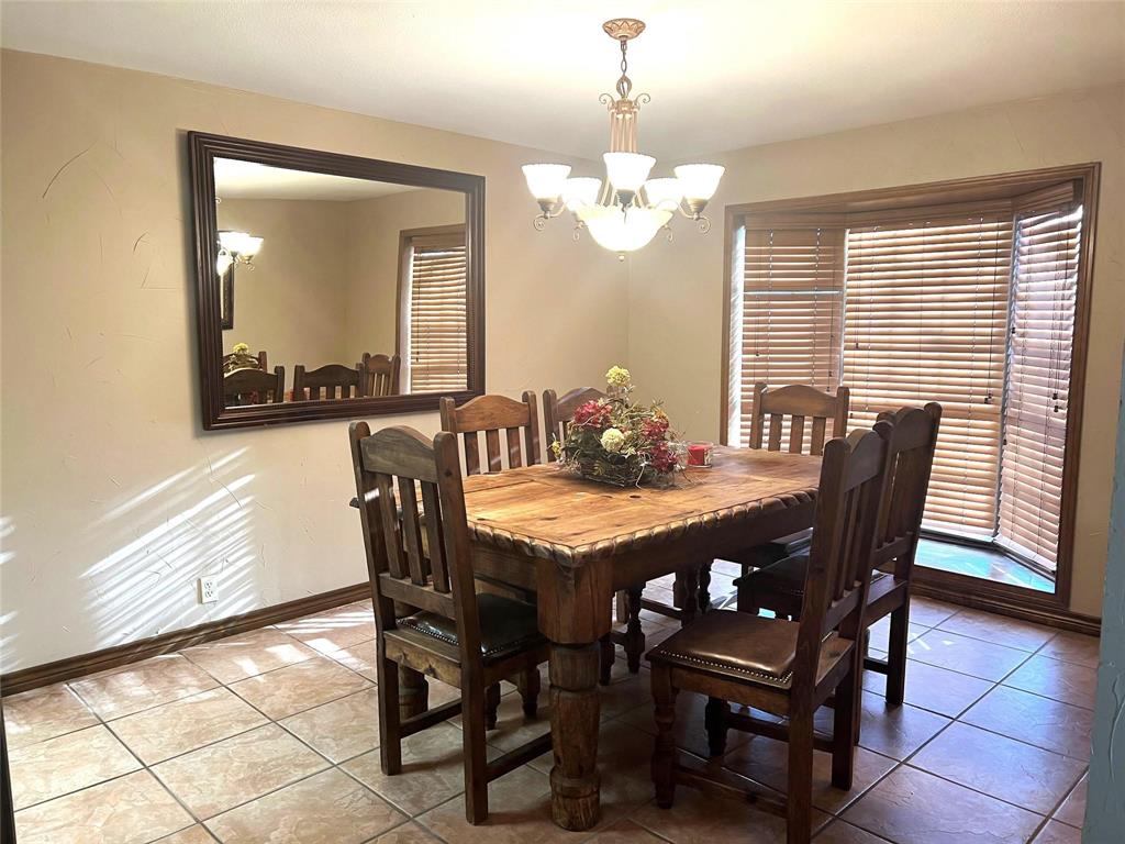 2815 Farm To Market Road 3092 Gainesville, TX 76240 - Photo 10 of 28 a view of a dining room with furniture and chandelier