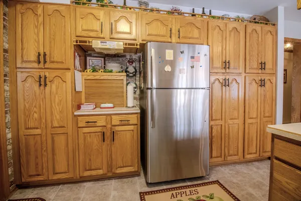 a refrigerator freezer sitting inside of a kitchen