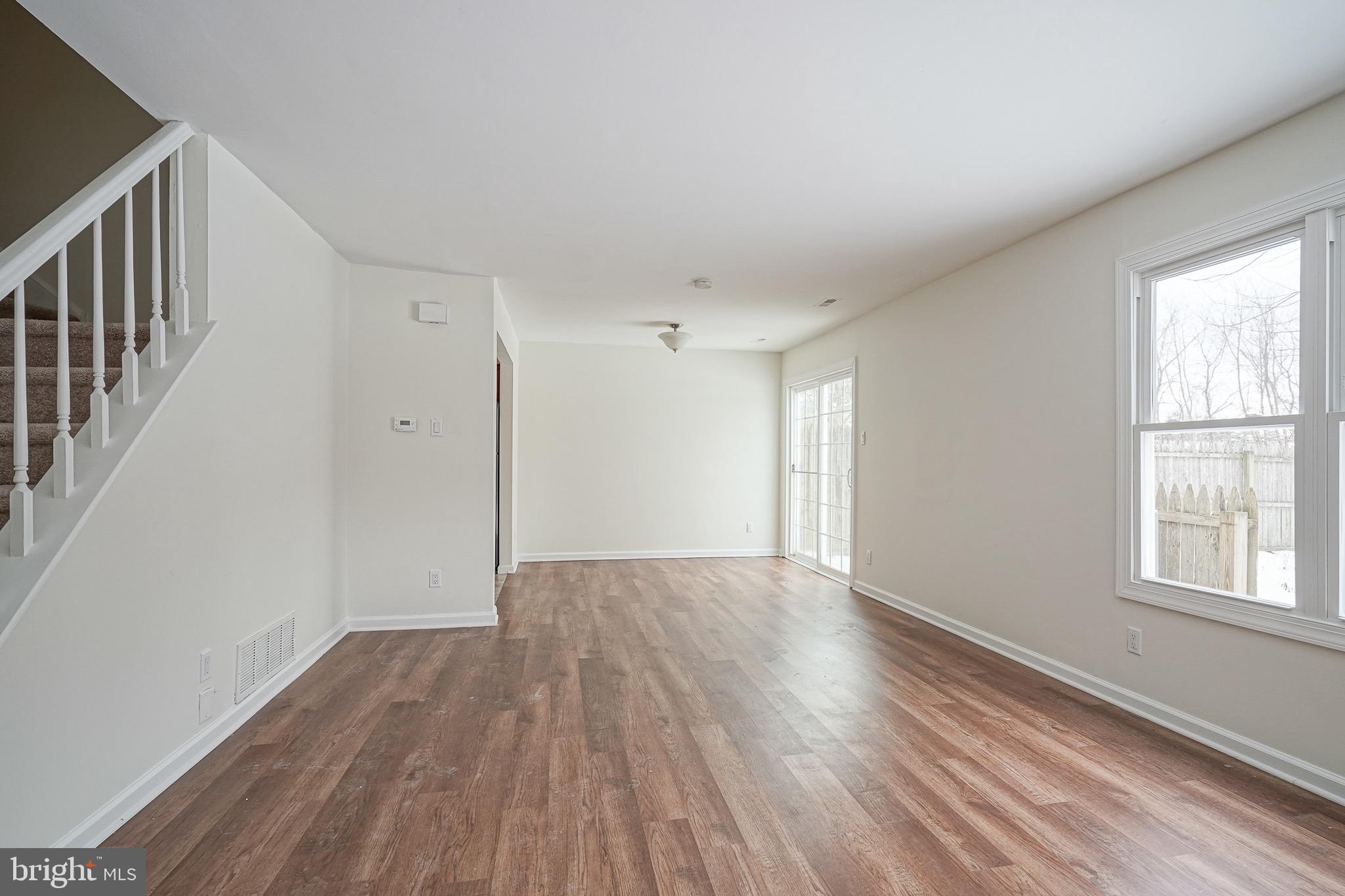 117 Chaucer Road Mount Laurel, NJ 08054 - Photo 3 of 20 a view of an empty room with wooden floor and a window
