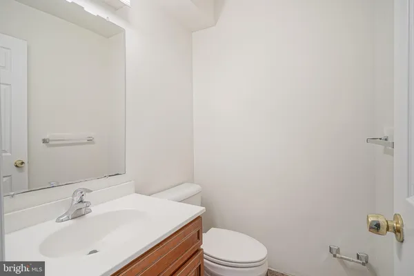 a bathroom with a sink a toilet and mirror