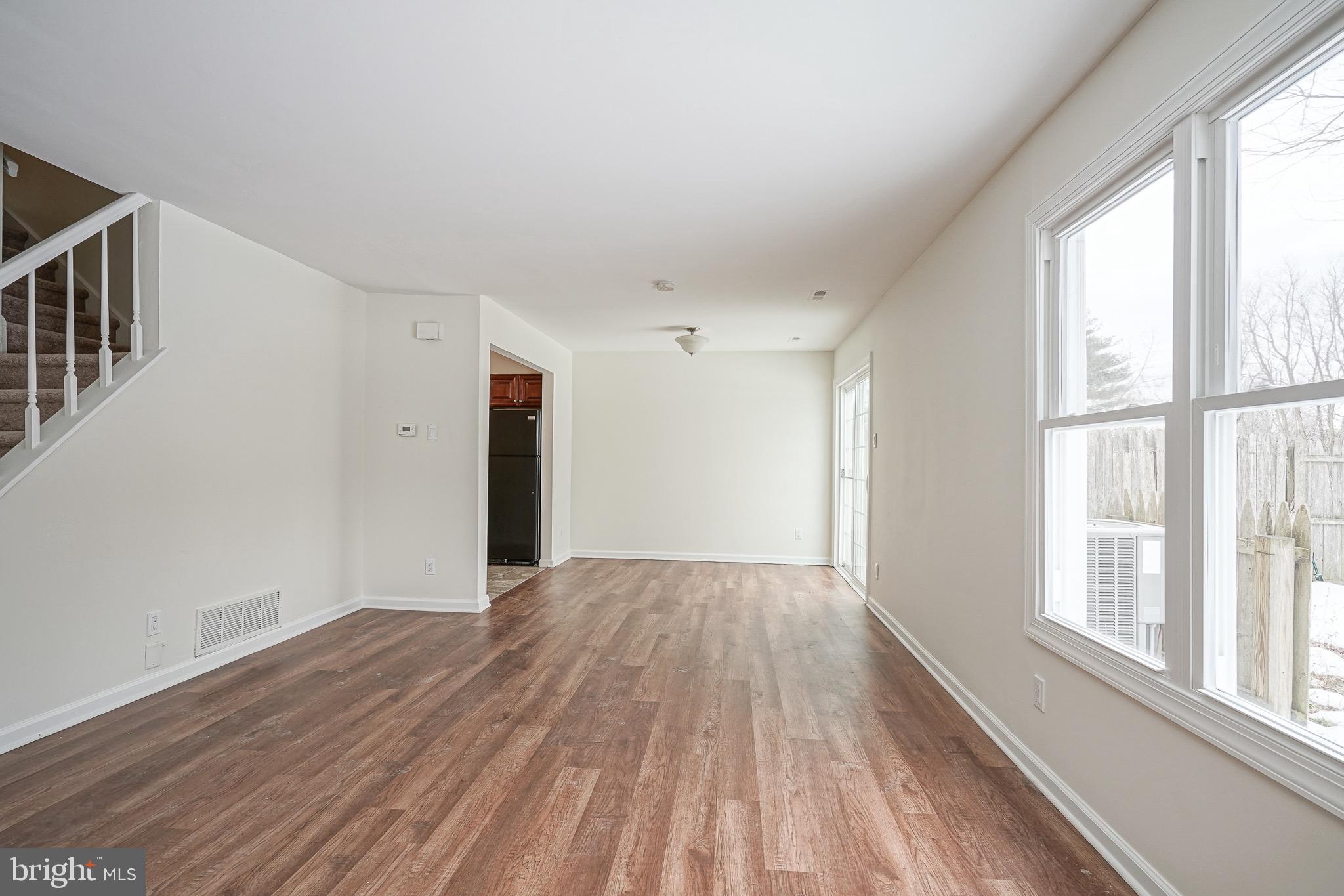 117 Chaucer Road Mount Laurel, NJ 08054 - Photo 8 of 20 a view of an empty room with wooden floor and a window
