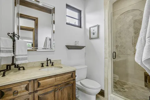 a bathroom with a sink toilet and shower