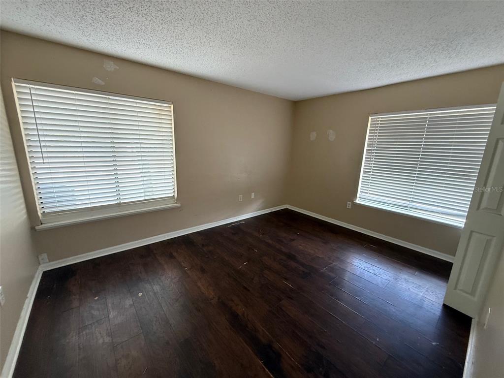 9085 Heather Boulevard Weeki Wachee, FL 34613 - Photo 11 of 15 a view of an empty room with wooden floor and a window