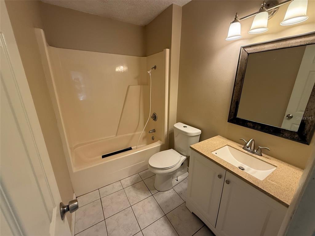9085 Heather Boulevard Weeki Wachee, FL 34613 - Photo 12 of 15 a bathroom with a granite countertop sink toilet and shower
