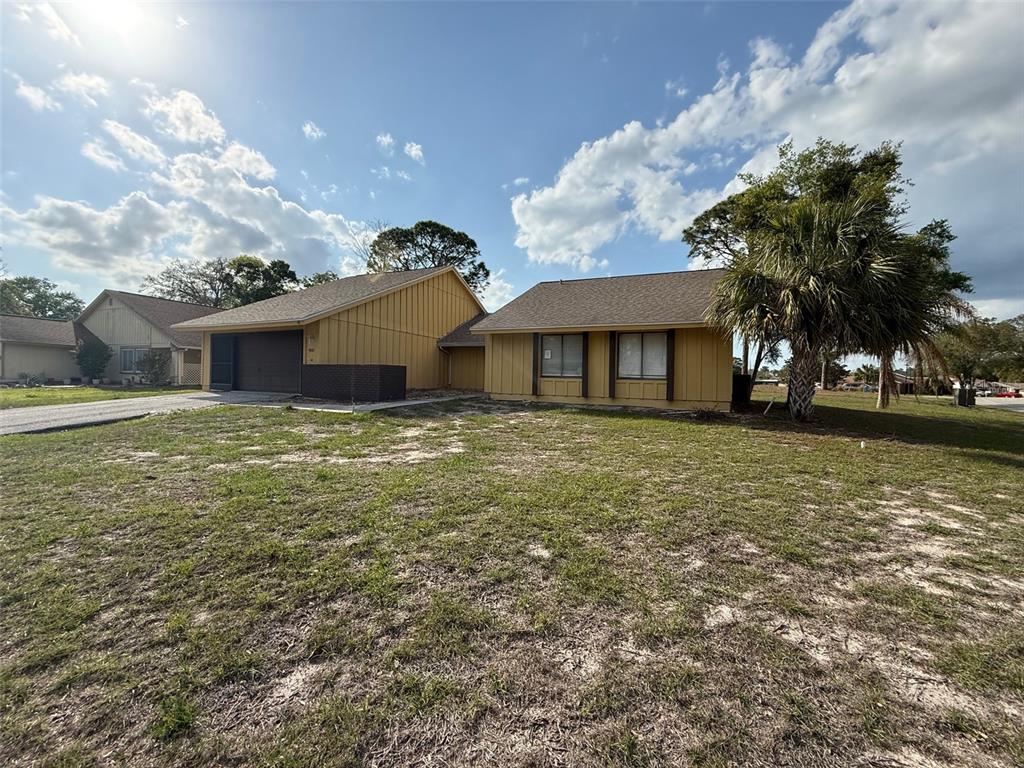 9085 Heather Boulevard Weeki Wachee, FL 34613 - Photo 14 of 15 a front view of a house with garden