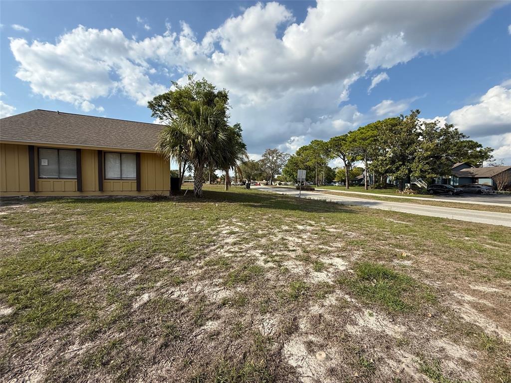 9085 Heather Boulevard Weeki Wachee, FL 34613 - Photo 15 of 15 a front view of a house with a garden and trees