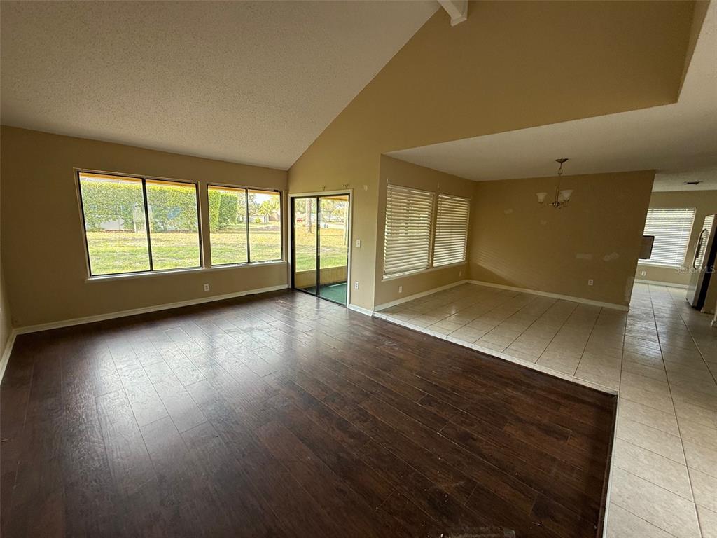 9085 Heather Boulevard Weeki Wachee, FL 34613 - Photo 3 of 15 an empty room with wooden floor and windows