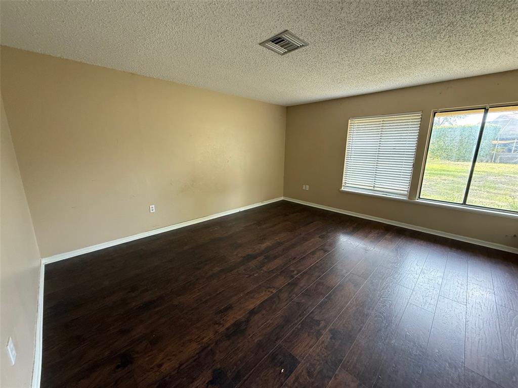9085 Heather Boulevard Weeki Wachee, FL 34613 - Photo 6 of 15 a view of an empty room with wooden floor and a window