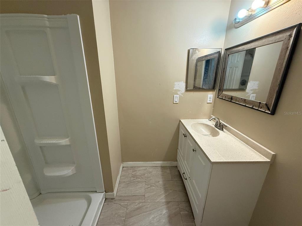 9085 Heather Boulevard Weeki Wachee, FL 34613 - Photo 8 of 15 a bathroom with a sink a mirror and a toilet