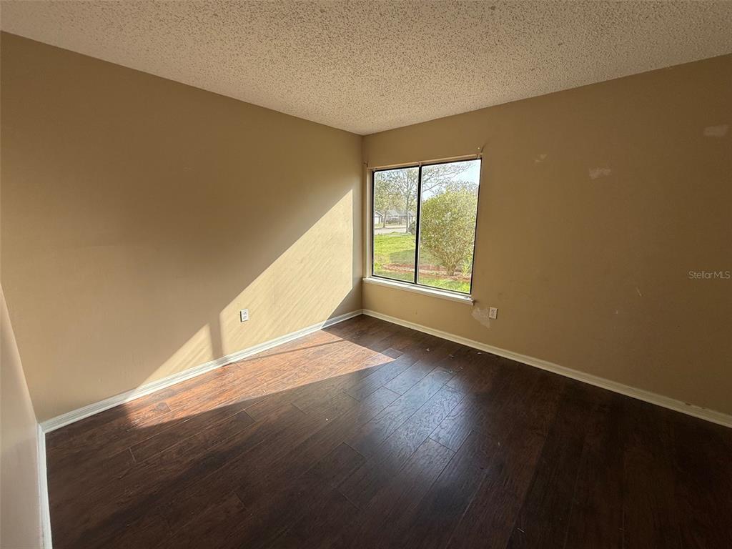 9085 Heather Boulevard Weeki Wachee, FL 34613 - Photo 9 of 15 a view of an empty room with wooden floor and a window