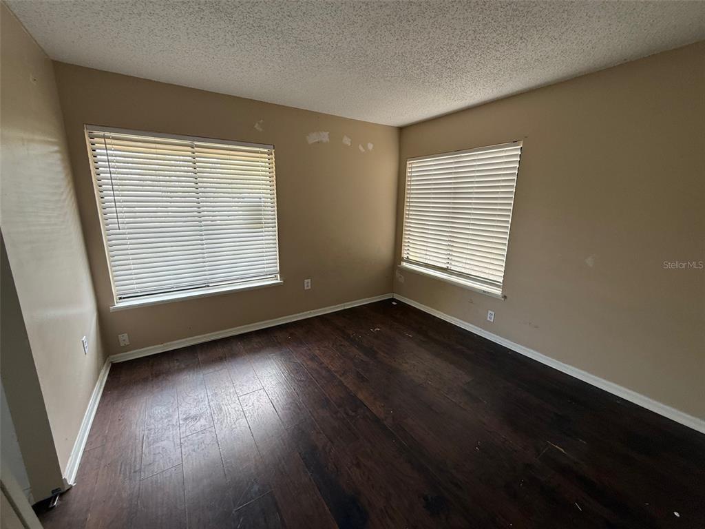 9085 Heather Boulevard Weeki Wachee, FL 34613 - Photo 10 of 15 a view of an empty room with wooden floor and a window